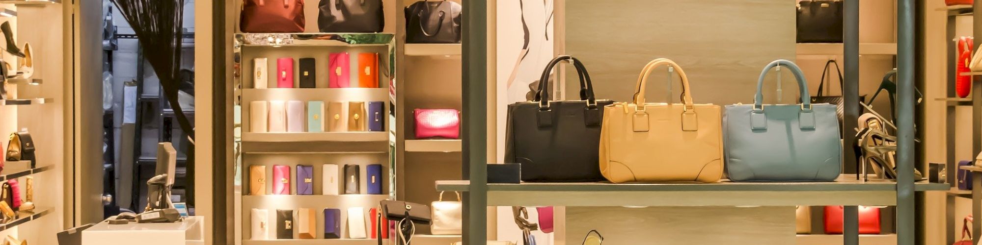 A stylish boutique store displaying handbags, shoes, and accessories on shelves, with a clean and elegant interior design.